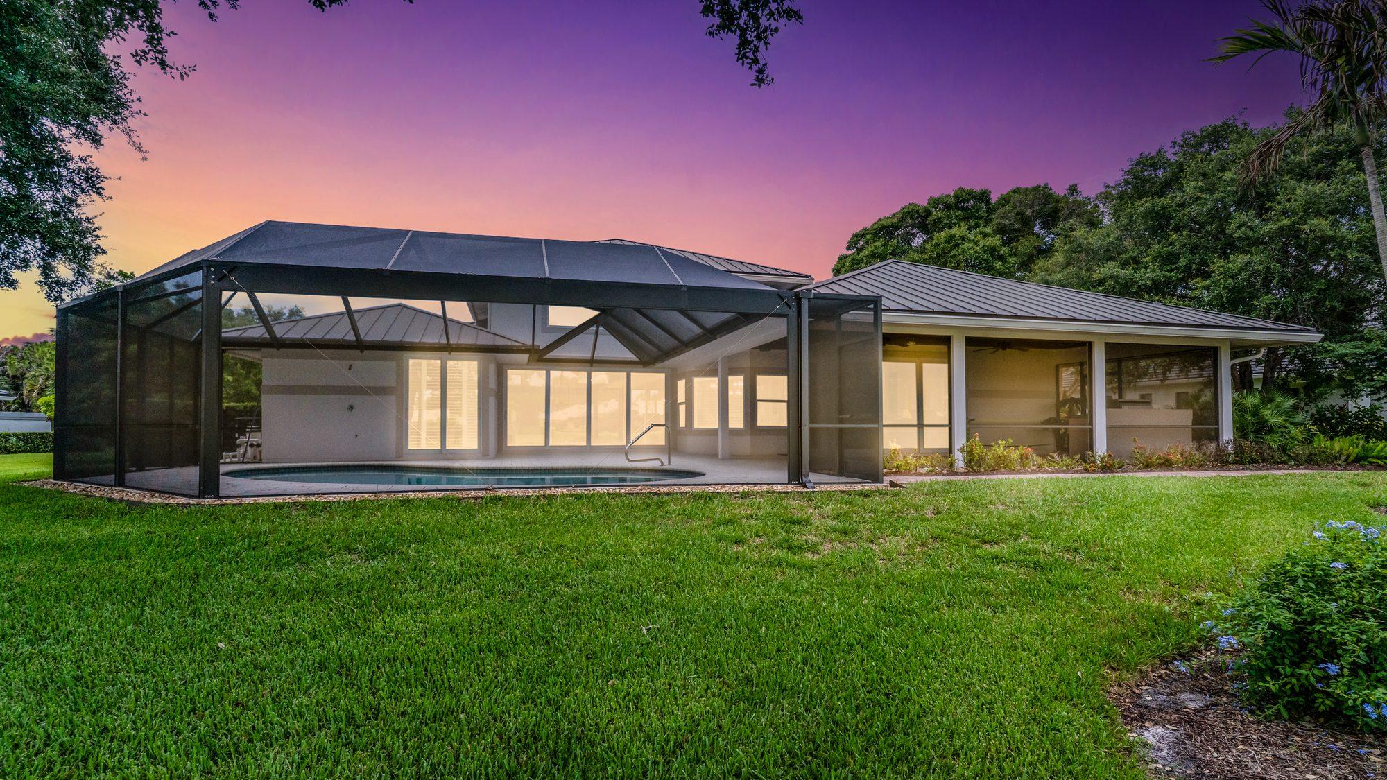 Virtual twilight rear exterior with pool enclosure